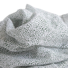 Little Unicorn swaddle Green Seed galaxy design laid flat for soothing style.