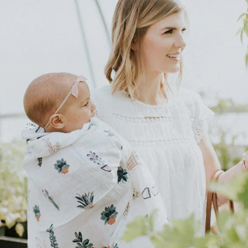 Little Unicorn blanket demonstrates safe-sleep-friendly swaddling for newborns.
