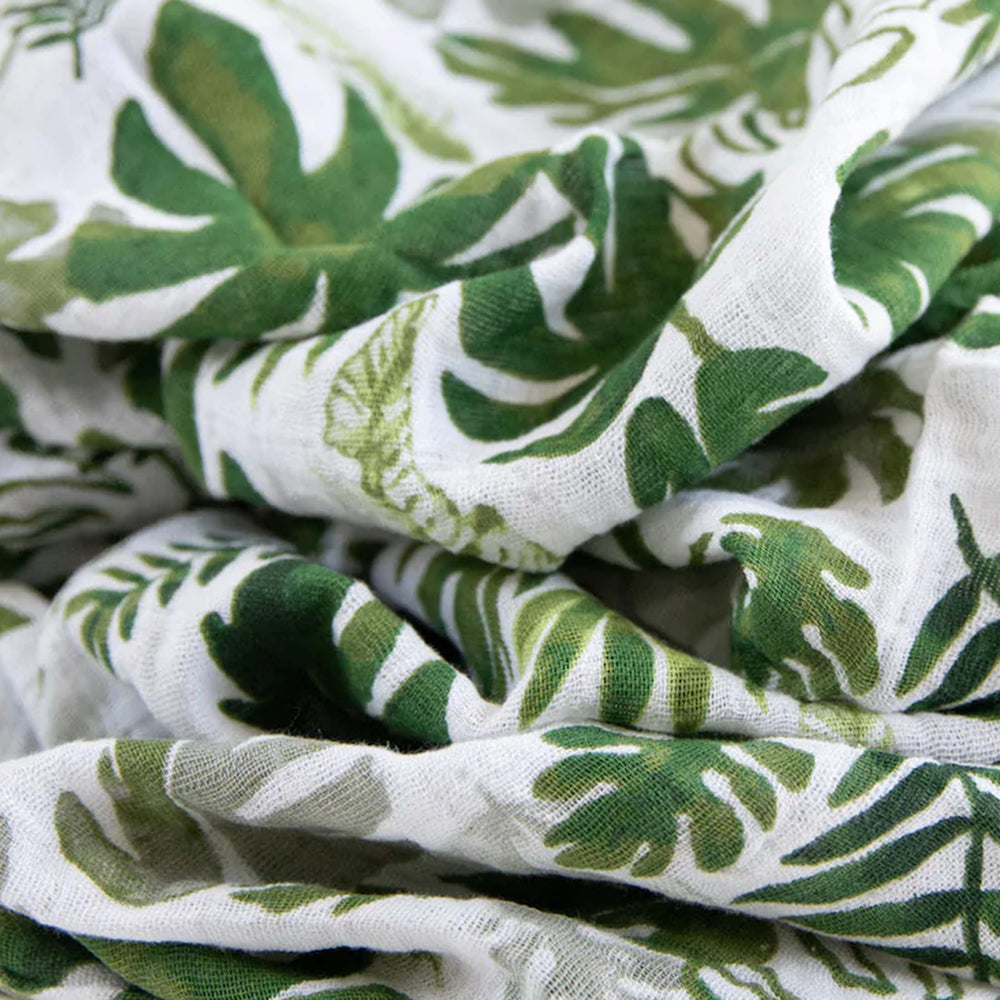 Little Unicorn swaddle Tropical Leaf in use for swaddling soothing newborns with premium cotton