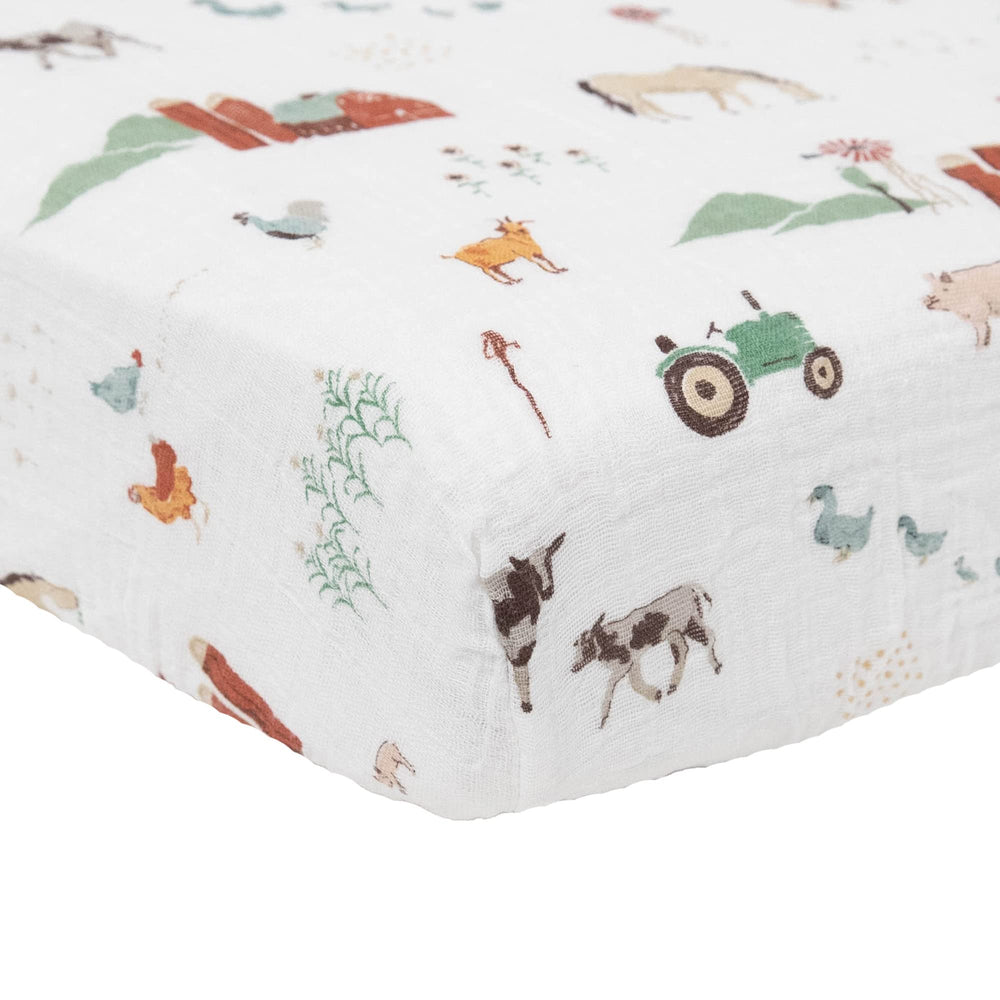 Little Unicorn Premium Crib Sheet elastic-fit image shows snug secure fit
