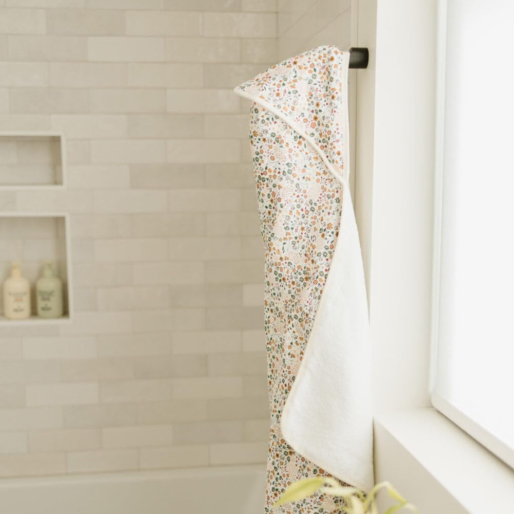 Little Unicorn hooded towel in use with newborn showing wrap potential