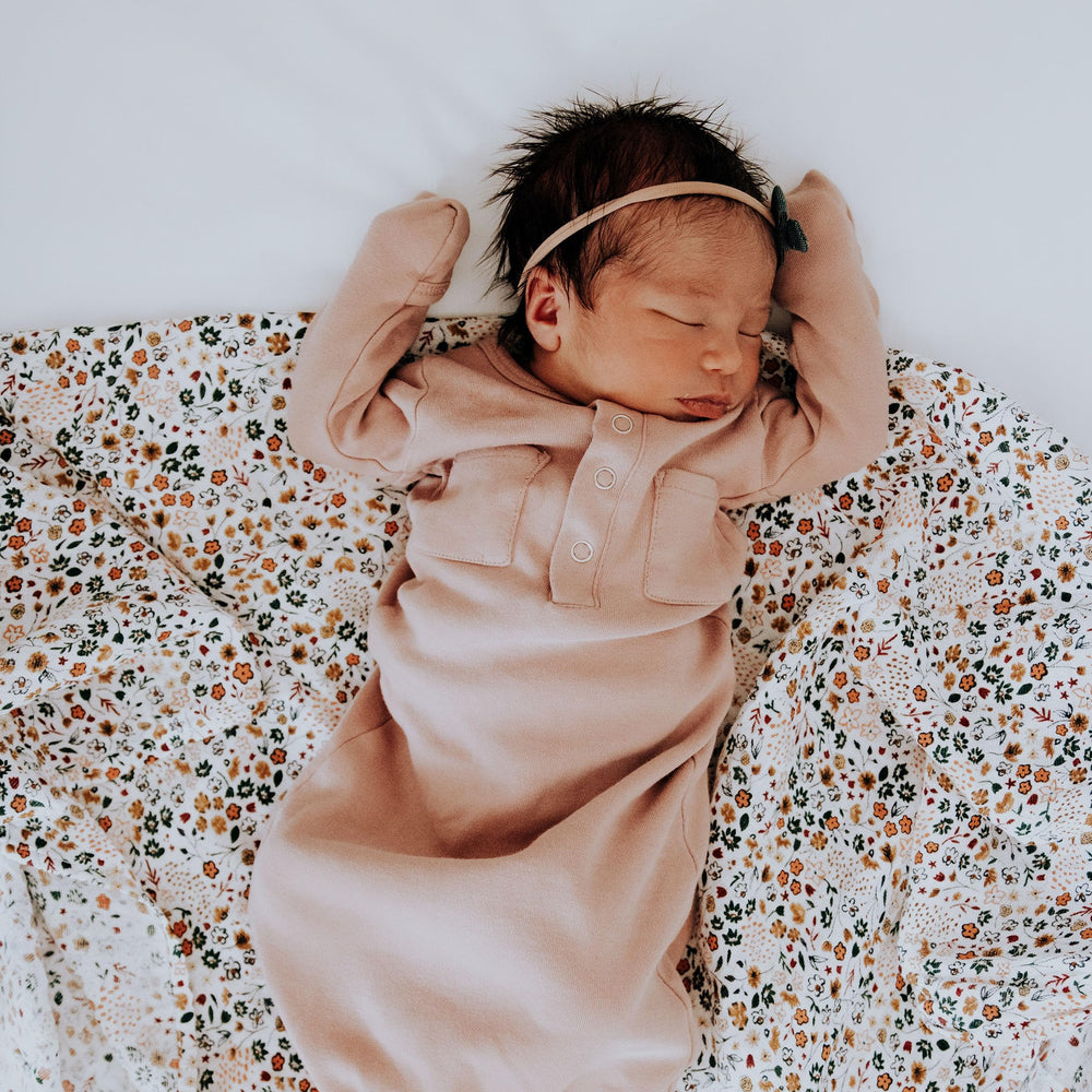 Little Unicorn swaddle blanket in nursery setting, gift-ready trio for baby gifting.