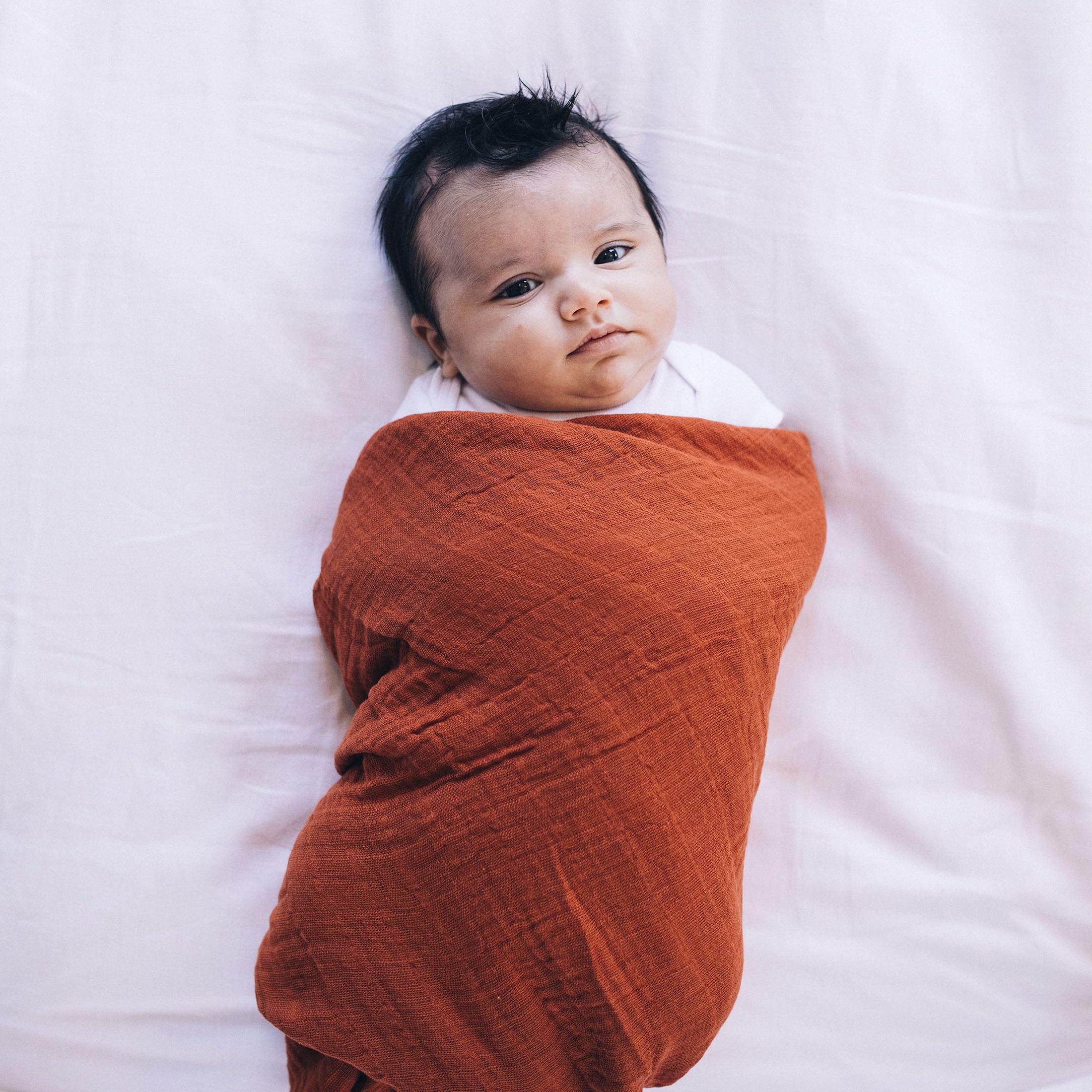 Little Unicorn blanket folds show color depth variation due to manufacturing process.