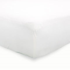 Little Unicorn premium stretch-knit crib sheet white snug-fit on mattress demonstrates secure, snug sleeping space.
