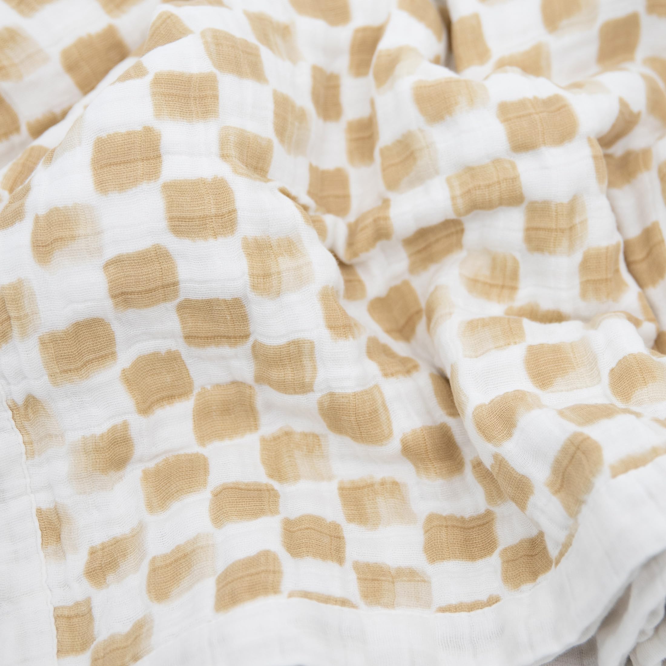 Little Unicorn quilt stroller cover provides on-the-go comfort during outings.