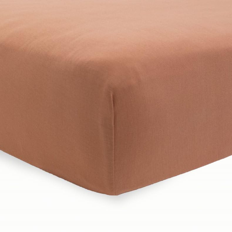 Little Unicorn terracotta stretch knit crib sheet close-up highlighting soft fabric
