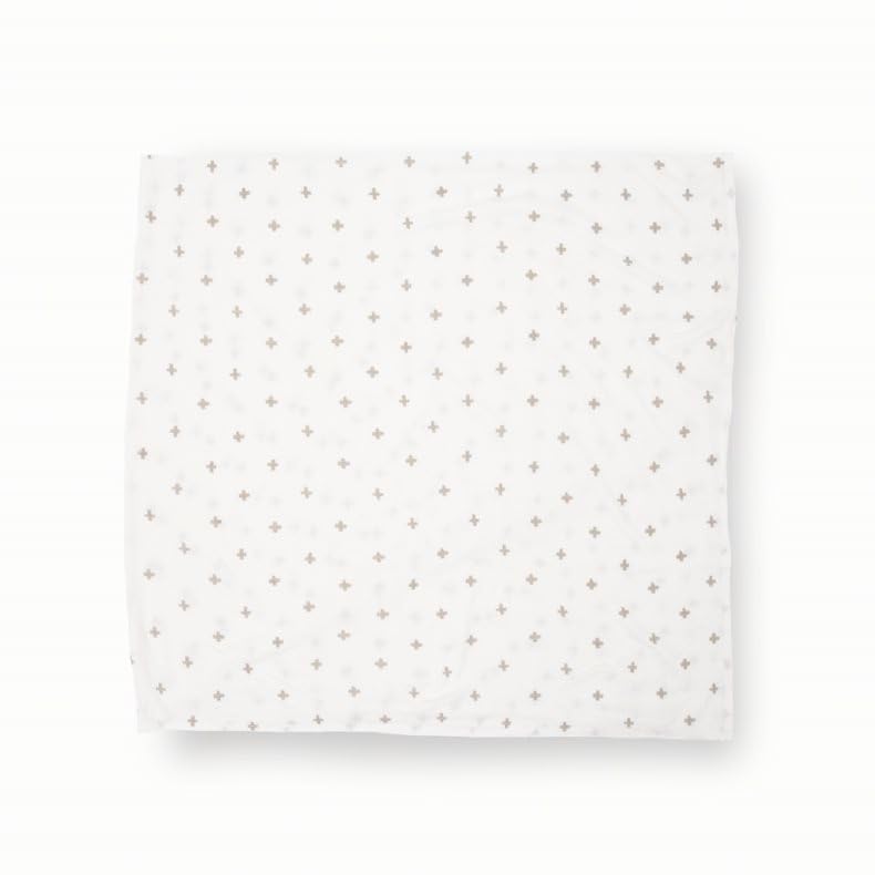 Little Unicorn swaddle blanket grey cross kept nearby for quick cuddles.