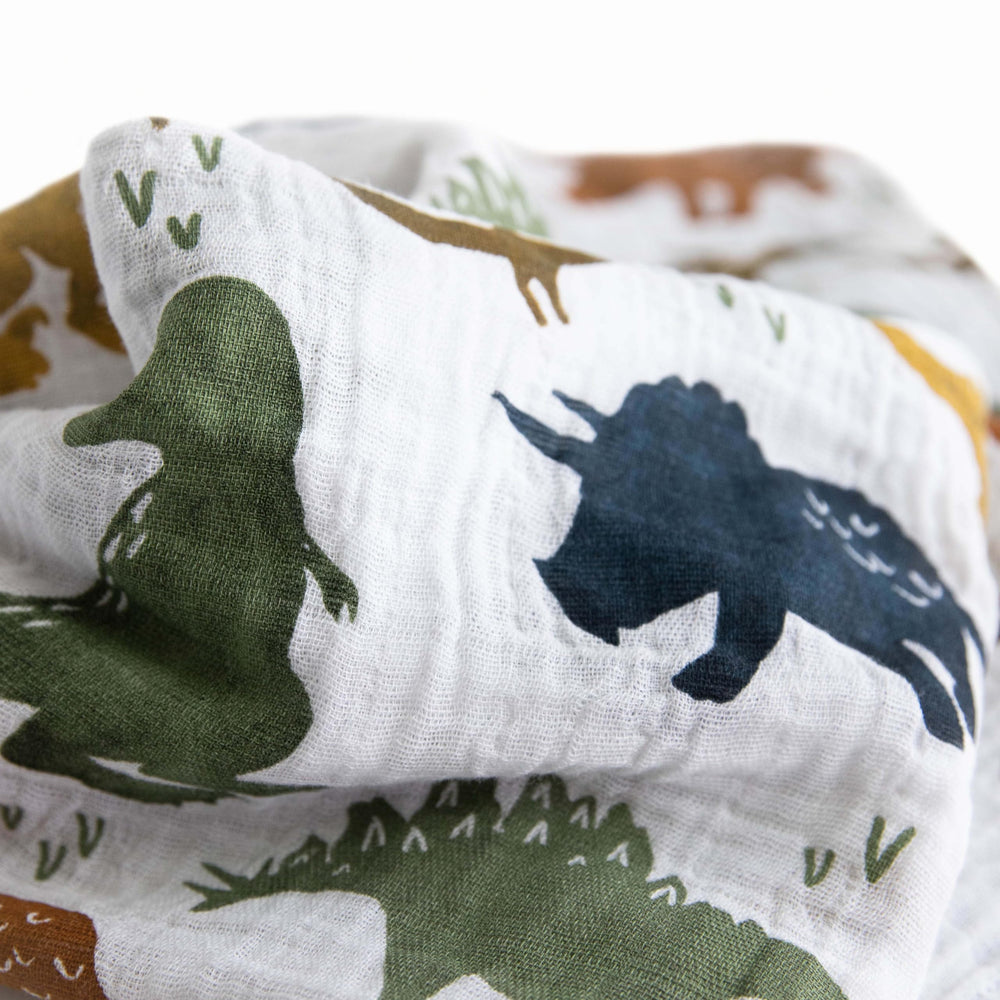 Little Unicorn swaddle dino friends demonstrates wrap-ready design for playtime