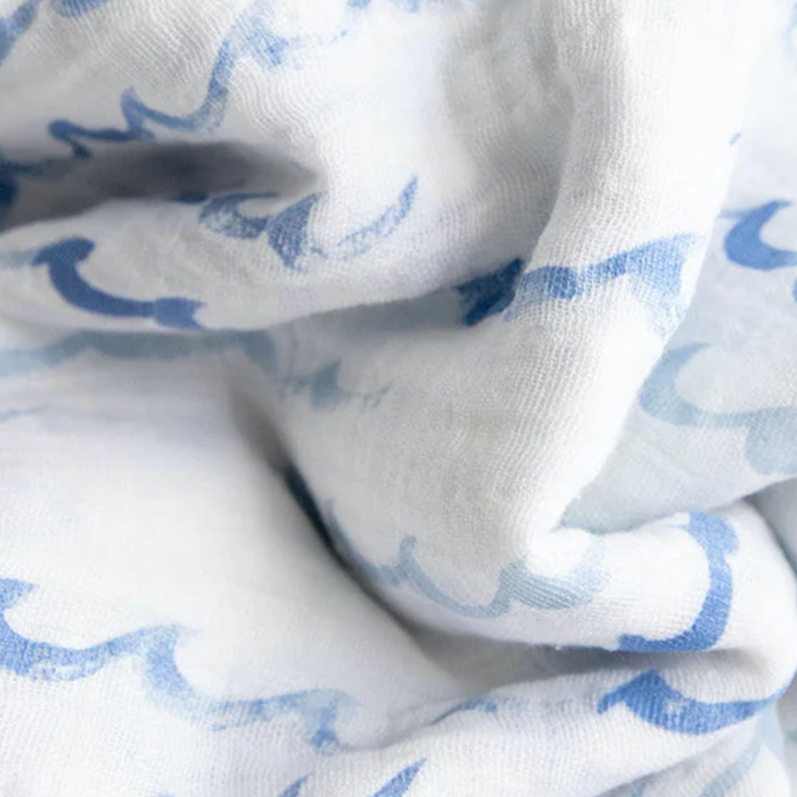 Little Unicorn swaddle highlighting easy-care, machine-washable fabric for busy parents.