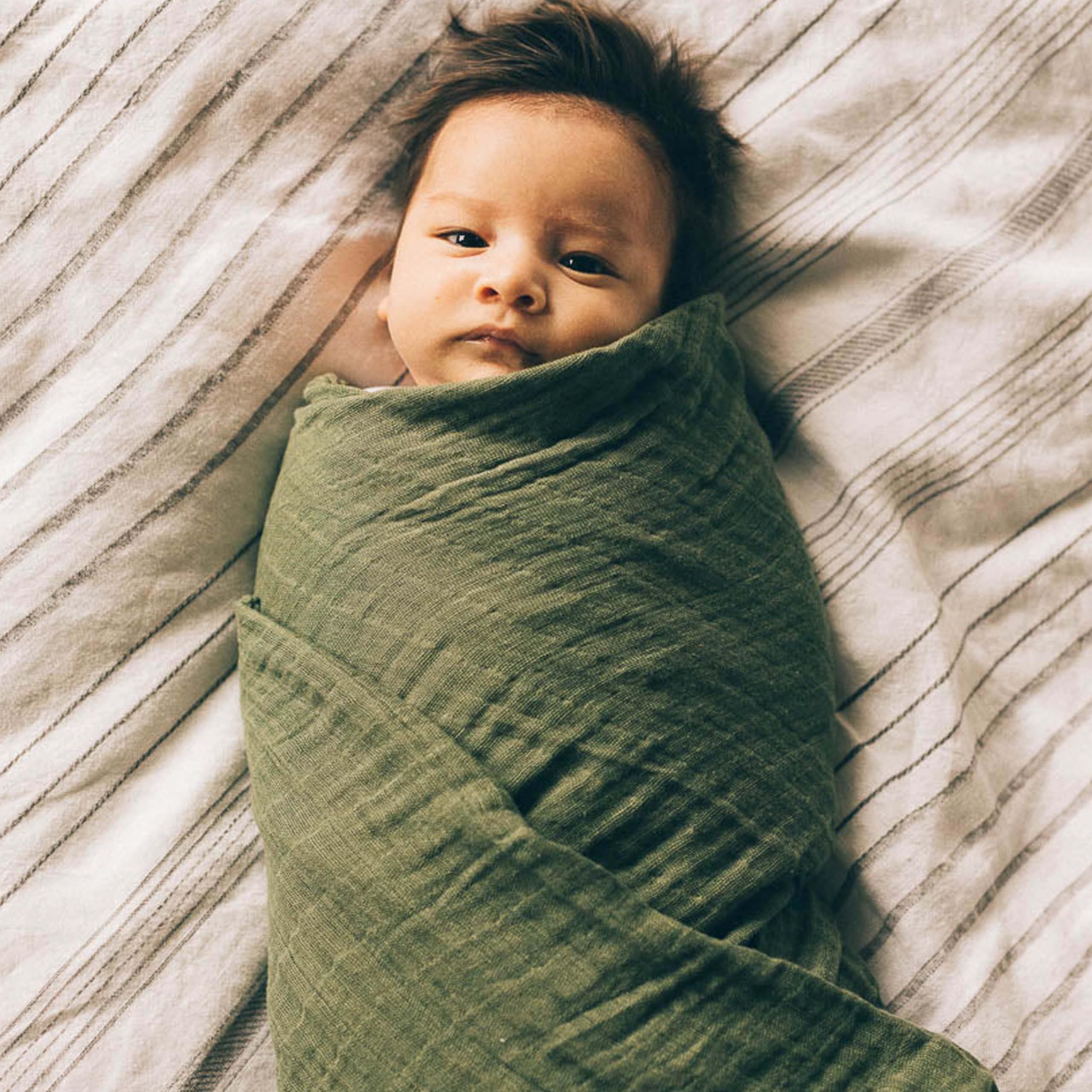 Little Unicorn Fern swaddle burp cloth; soft layer for quick cleaning.