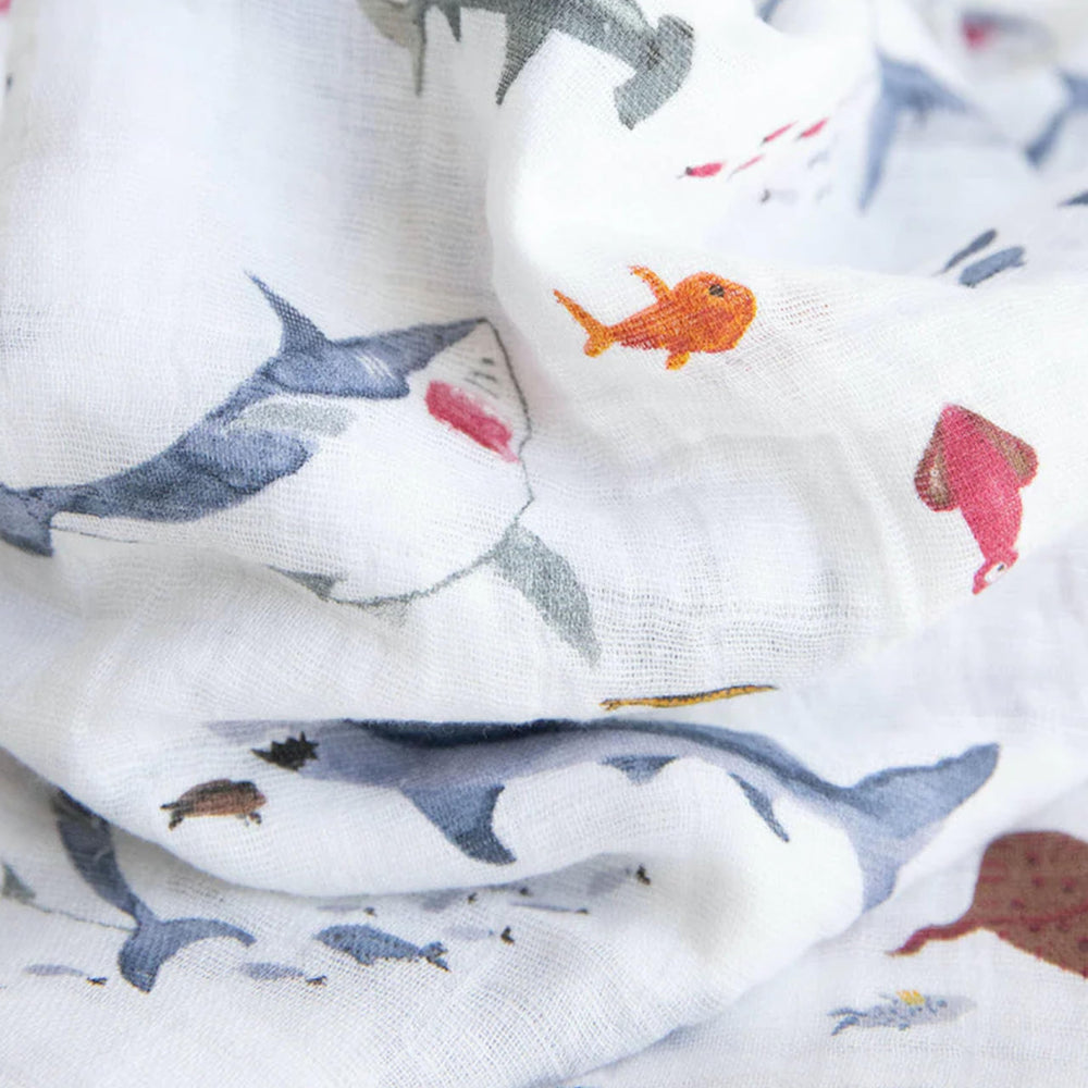 Little Unicorn swaddle demonstrating indoor-outdoor versatility as stroller cover or car seat wrap.