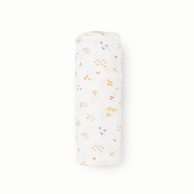 Little Unicorn swaddle rainbows wrapped around car seat for secure, comfortable travel.
