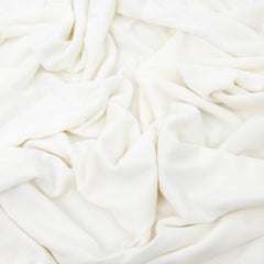 Little Unicorn swaddle wrapped baby showing buttery-soft viscose for secure sleep