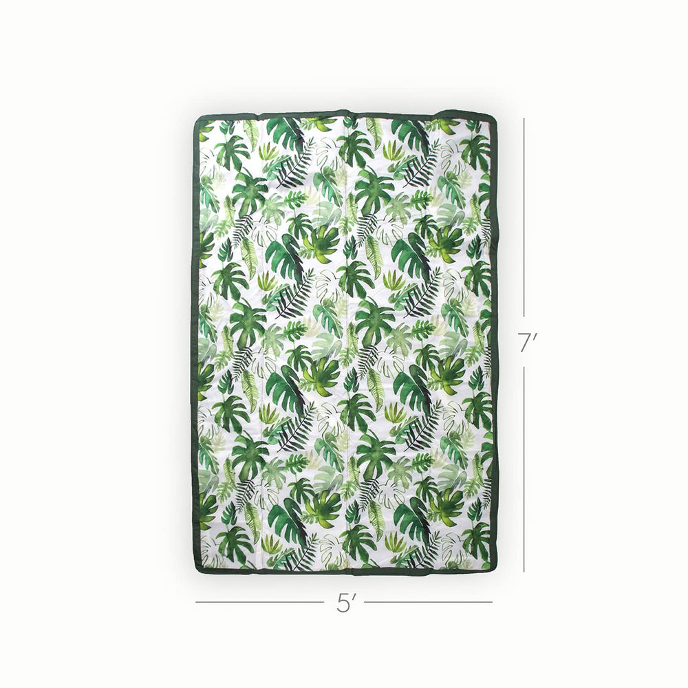 Little Unicorn tropical leaf blanket over the shoulder for hands-free picnics