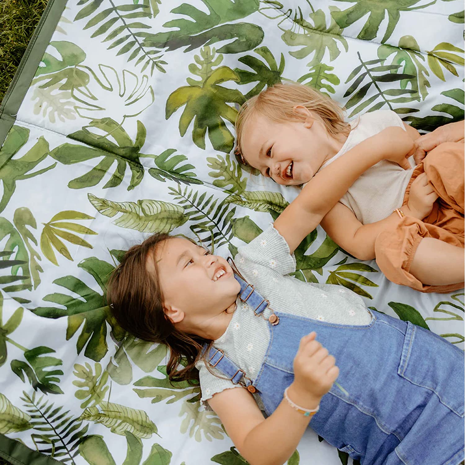 Little Unicorn tropical leaf blanket with zipper pocket for essentials