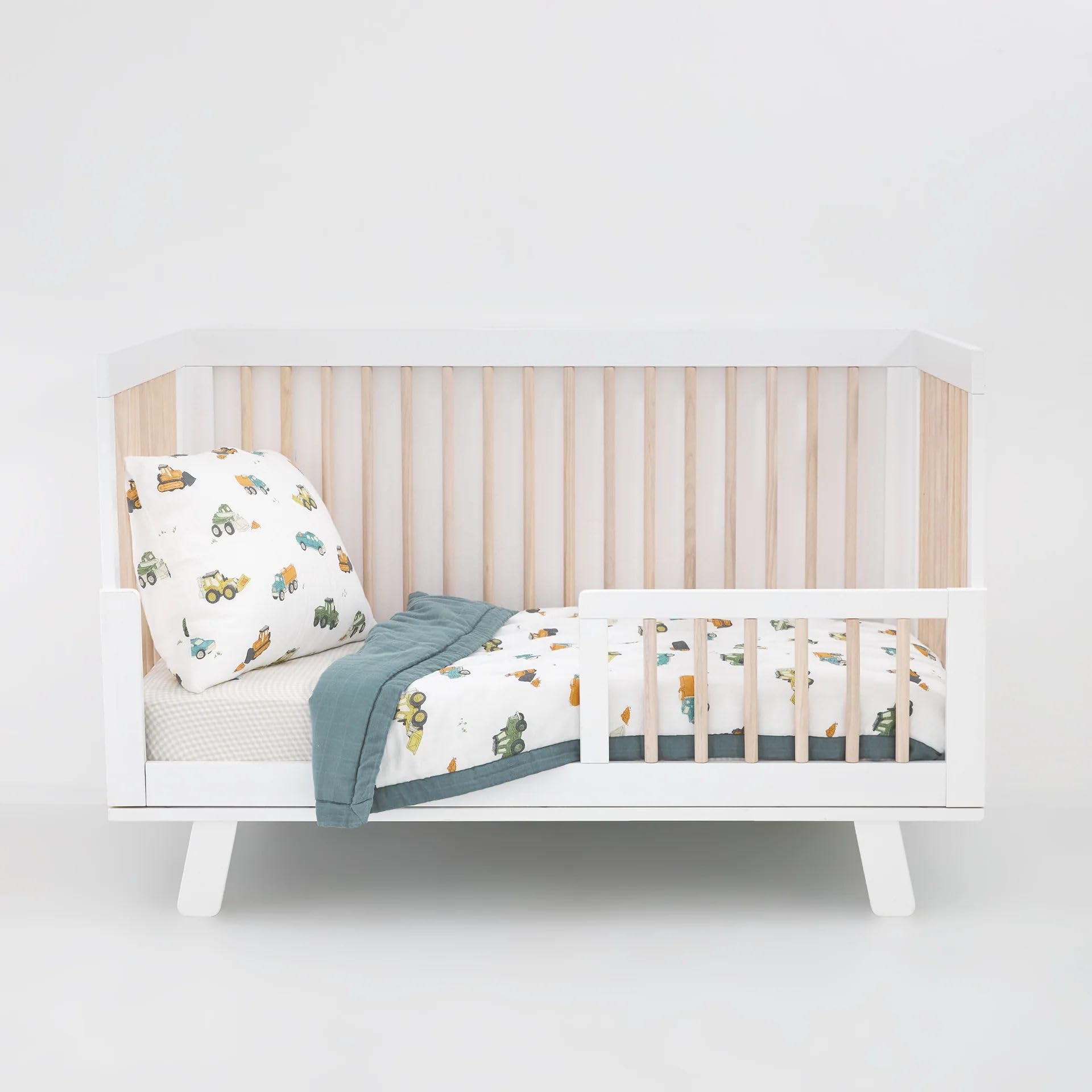 Little Unicorn work-trucks comforter close-up shows soft, lightweight warmth.