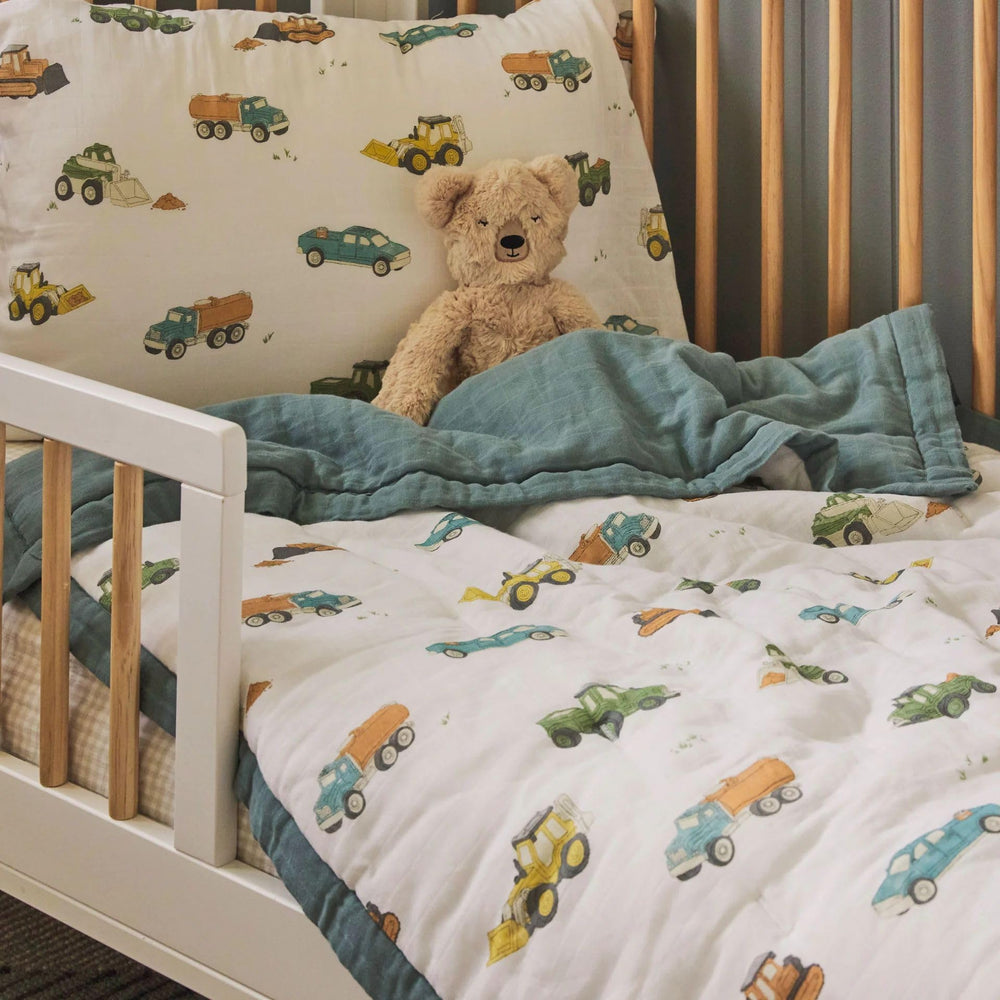 Little Unicorn work-trucks nursery-look cozy setup for a toddler room.
