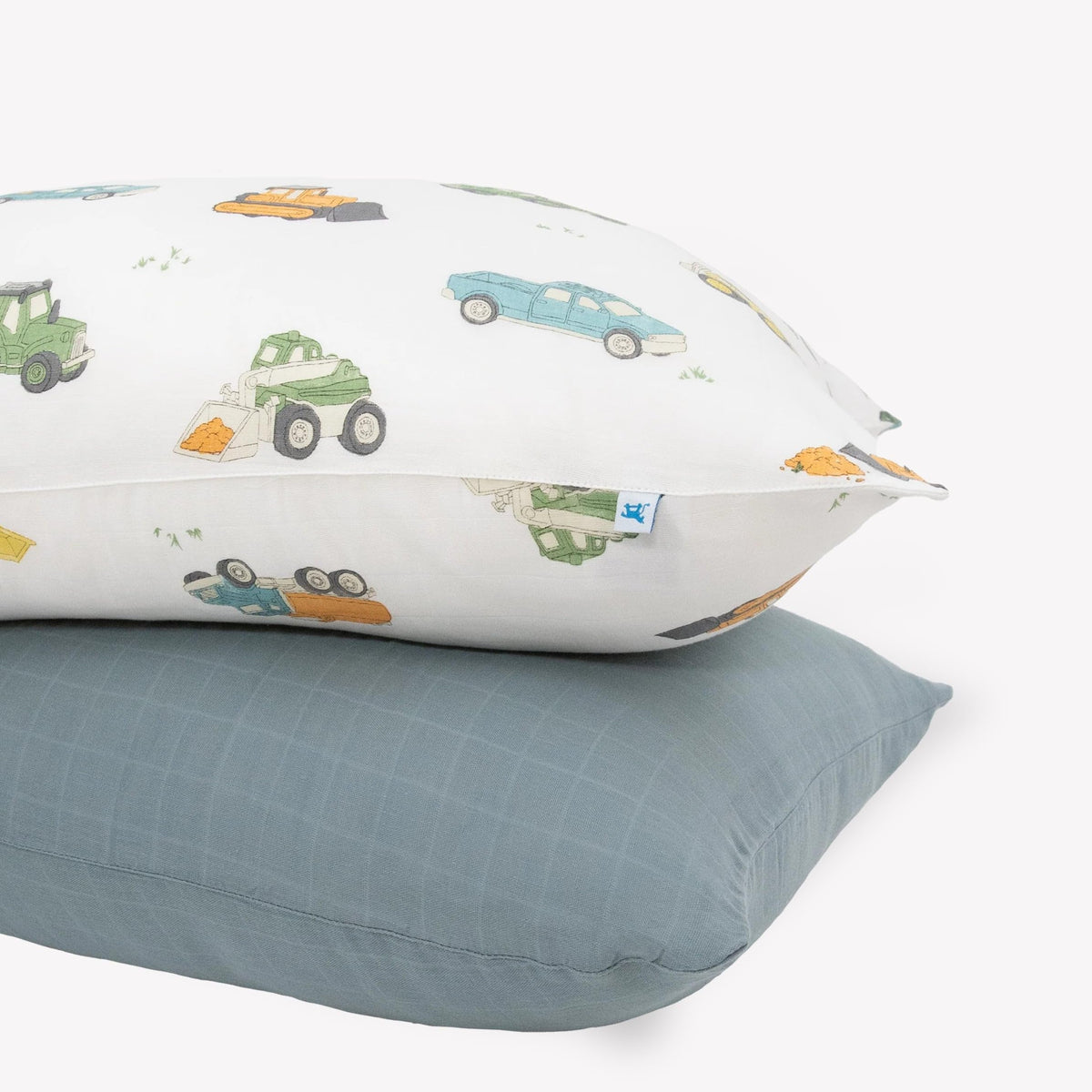 Little Unicorn work trucks pillowcase pack offers cozy muslin softness and secure fit.