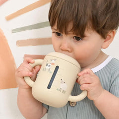 Little Rawr beige leak-proof double-seal sippy cup prevents spills during playtime.