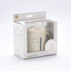 Little Rawr beige soft-spout sippy cup comfortable for teething and gradual sipping.
