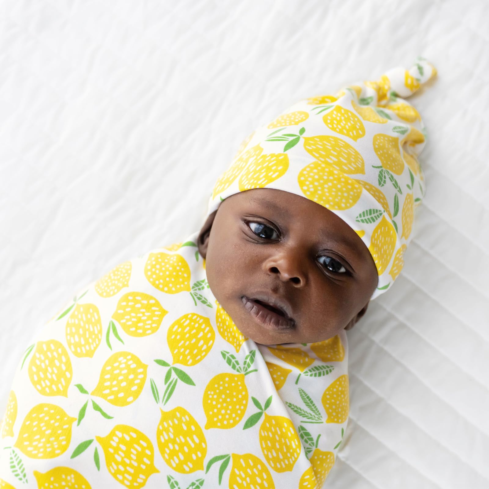 Little Sleepies lemon swaddle fabric close-up shows airy viscose from bamboo weave for breathable comfort.