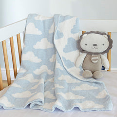 Living Textiles Blue Clouds Chenille blanket used as a swaddle option for newborns.