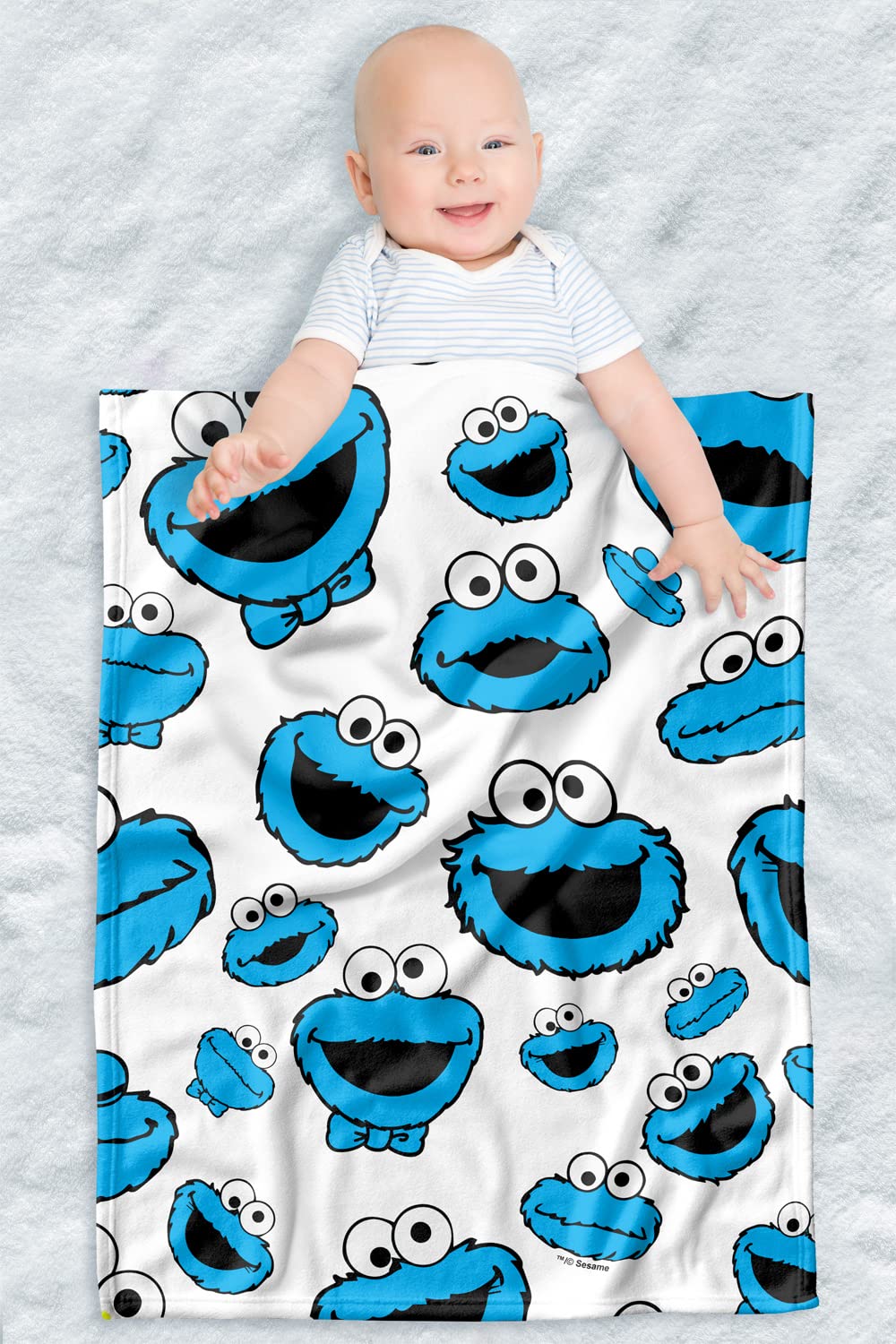 LOGOVISION Sesame Street lightweight baby blanket with cookie face pattern for cozy on-the-go moments.