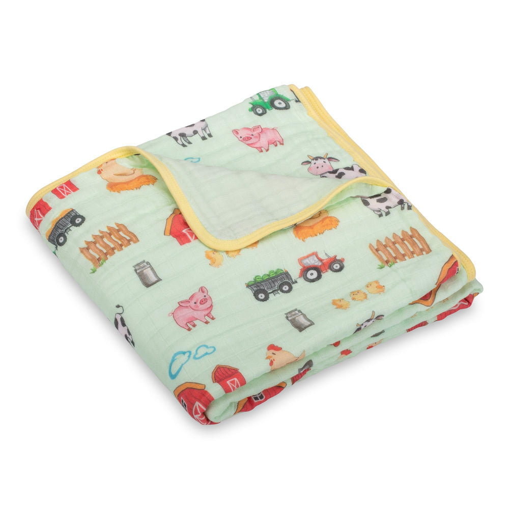 LollyBanks muslin blanket with farm theme illustration for gentle nursery snuggles.