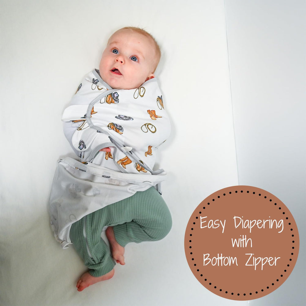LollyBanks baby boy cowboy-print swaddle wrapped for cozy newborn sleep.