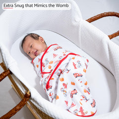 LollyBanks dog-print swaddle wrapped baby demonstrates secure snug fit with wings
