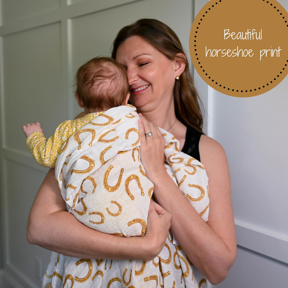 LollyBanks muslin swaddle beside diaper bag for on-the-go mess management
