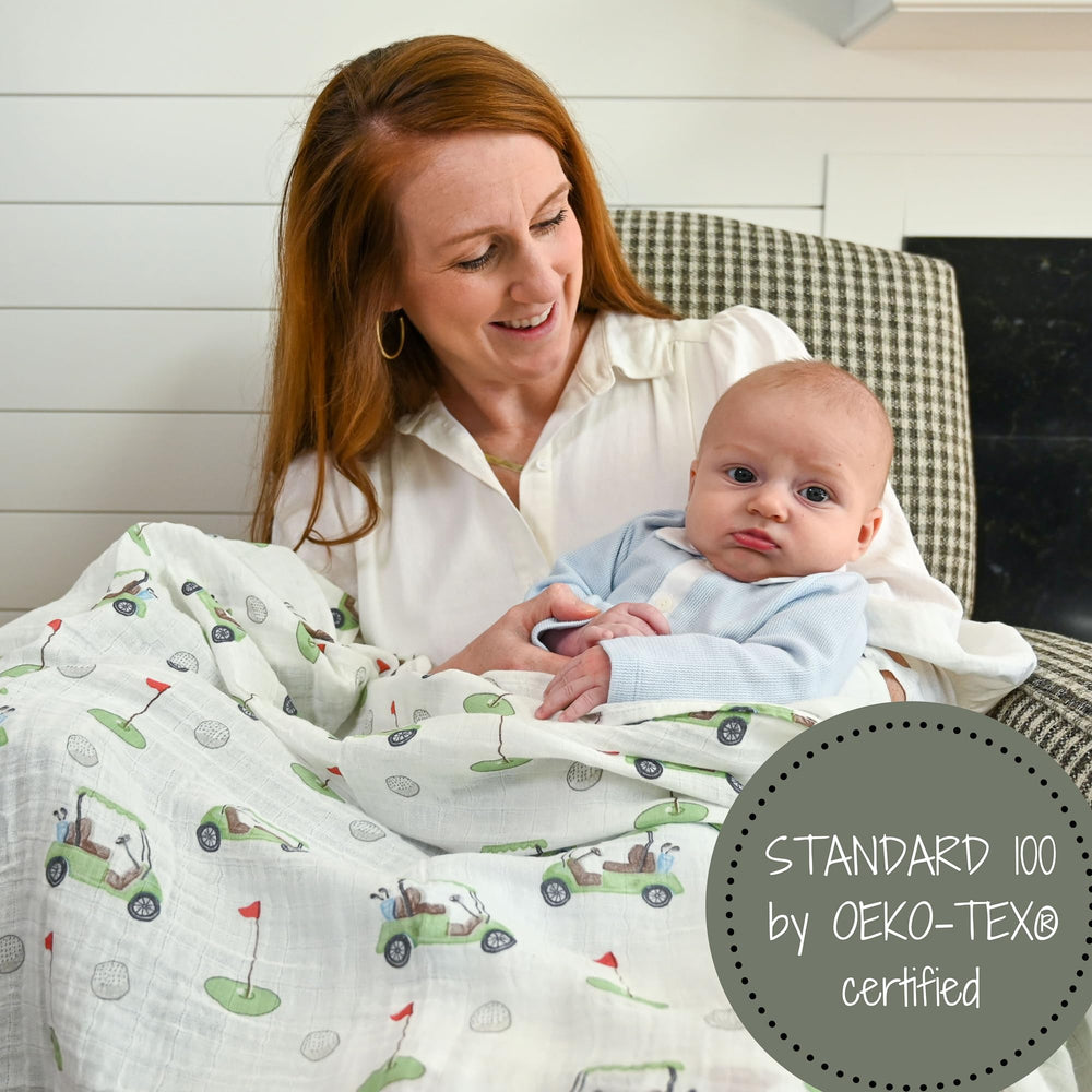 LollyBanks golf-print swaddle on crib as nursery decor