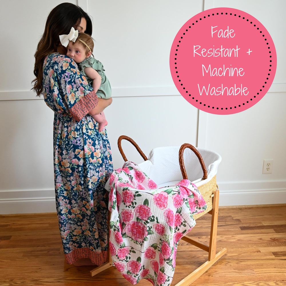 LollyBanks nursery decor idea with peony swaddle on the crib accent.