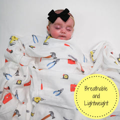 LollyBanks tool box print blanket on changing table shows lightweight comfort during on-the-go moments.