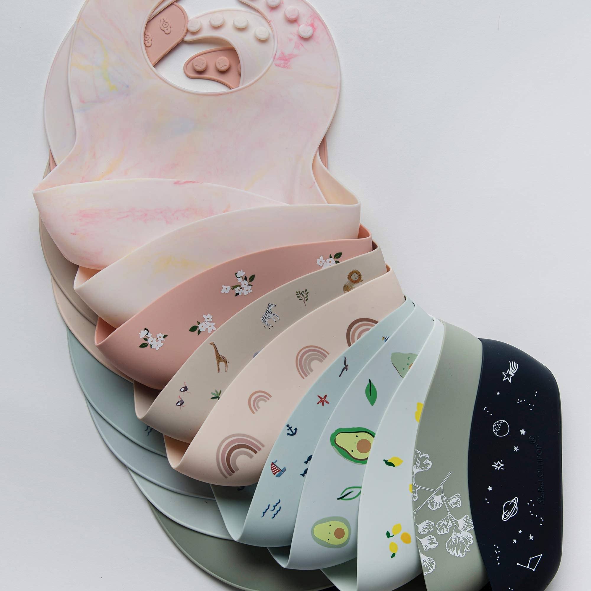 Loulou Lollipop avocado bib prevents spills near the high chair tray