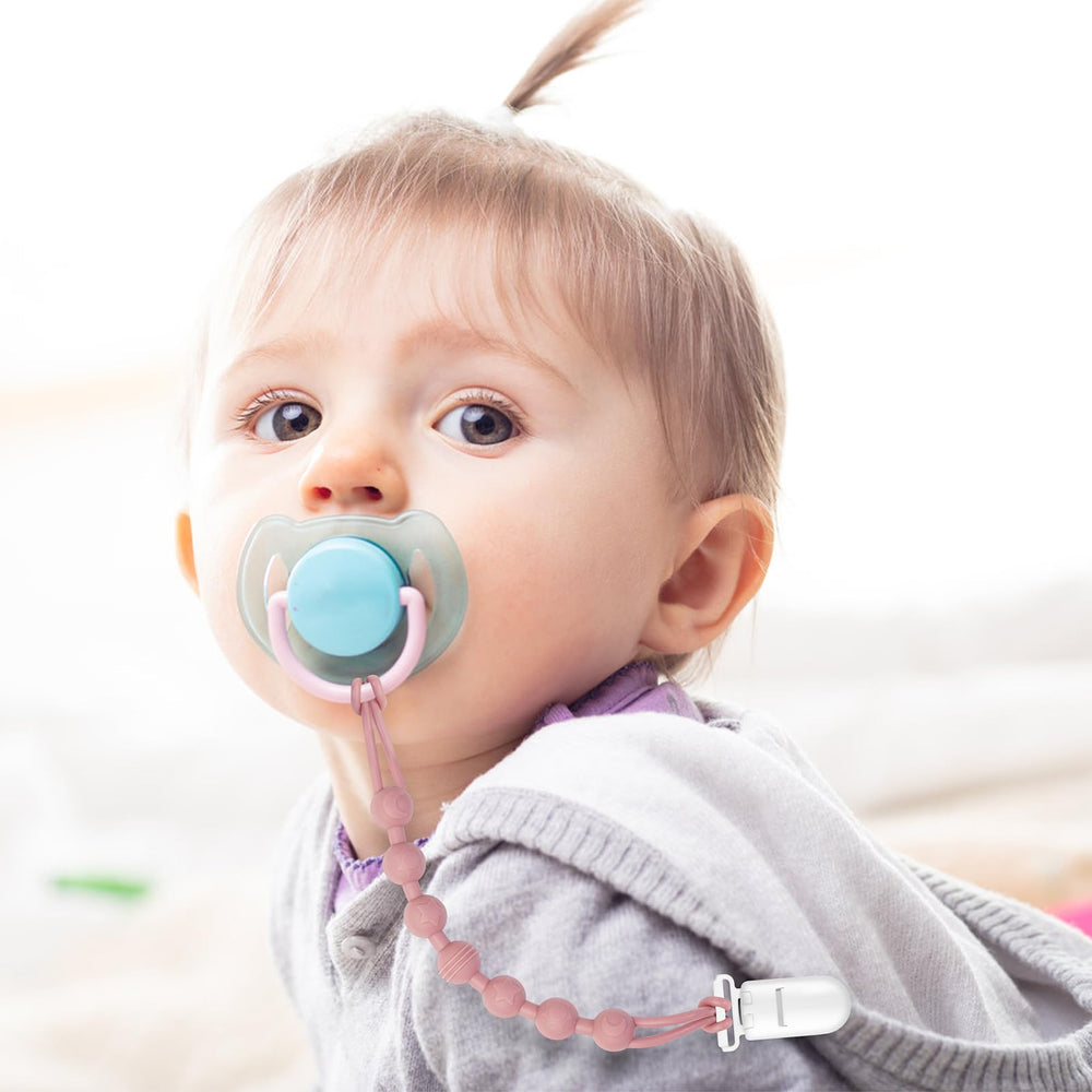 Loviomad pacifier clip on clothing demonstrates dropless outings and clean pacifiers.
