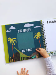 Lucy Darling Baby Journal pages open showing milestone sections and photo space
