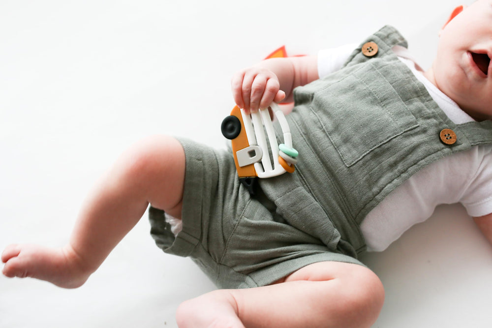 Lucy Darling Little Camper teether easy-grip design supports independent exploration.