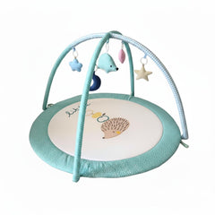 LULLABY COTTON play gym overhead arches provide a soft, safe space for newborn exploration.