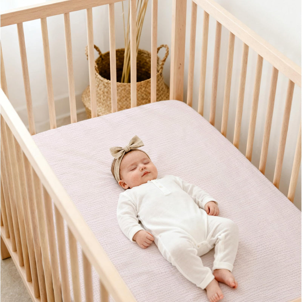 Lulu Moon muslin crib sheets breathable material close-up for temperature comfort.
