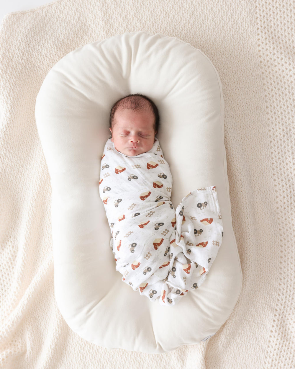 Lulujo Baby Swaddle Nursing Cover use shown with blanket draped.
