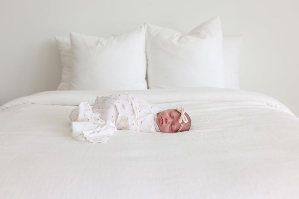 Lulujo swaddle provides a soft, shade-ready stroller cover for sunny days.