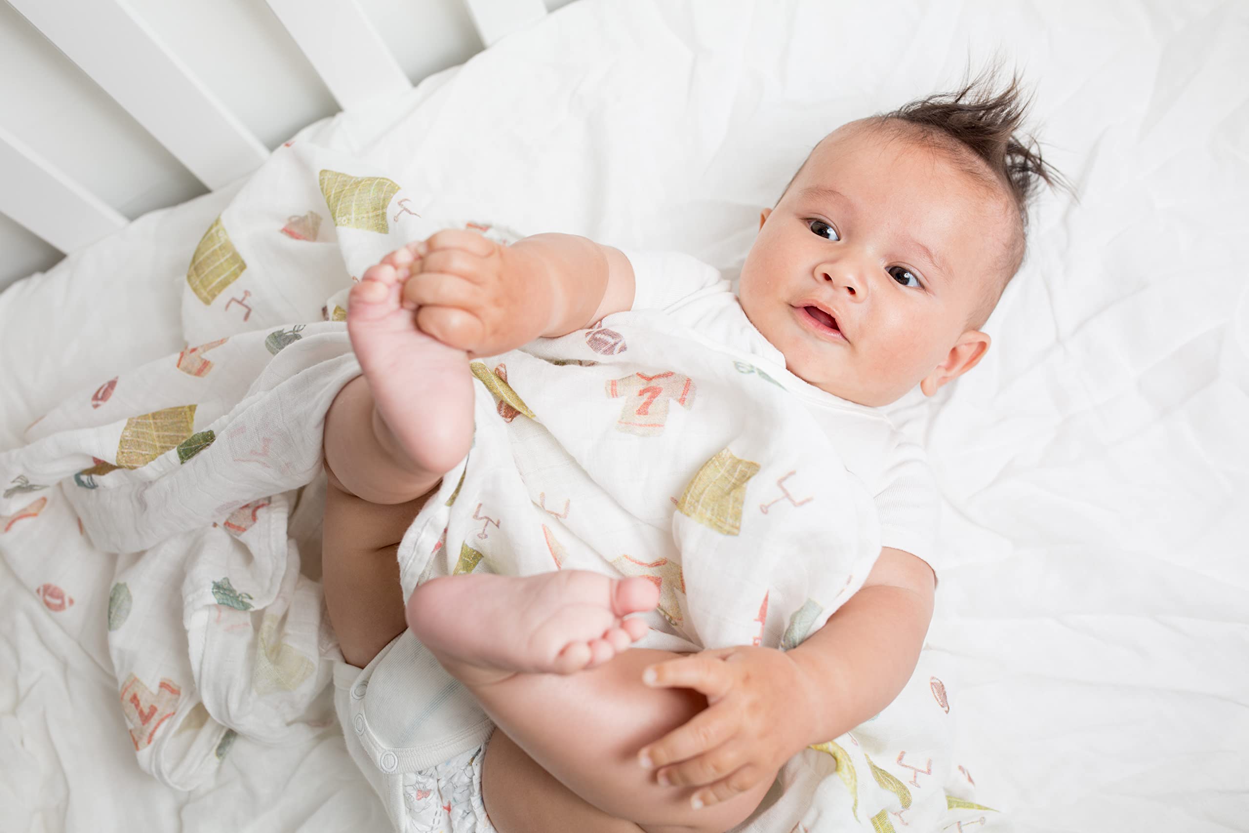 Lulujo football swaddle stroller shield demonstrates multipurpose protection during outings.