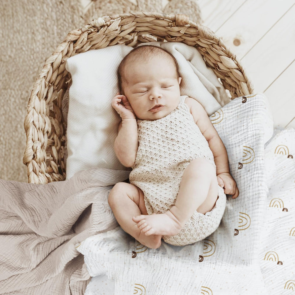 Lulumoon baby muslin swaddle blanket in use for cozy swaddling.