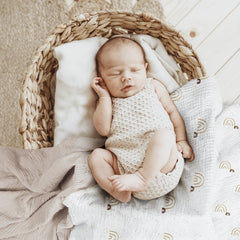 Lulumoon baby muslin swaddle blanket in use for cozy swaddling.