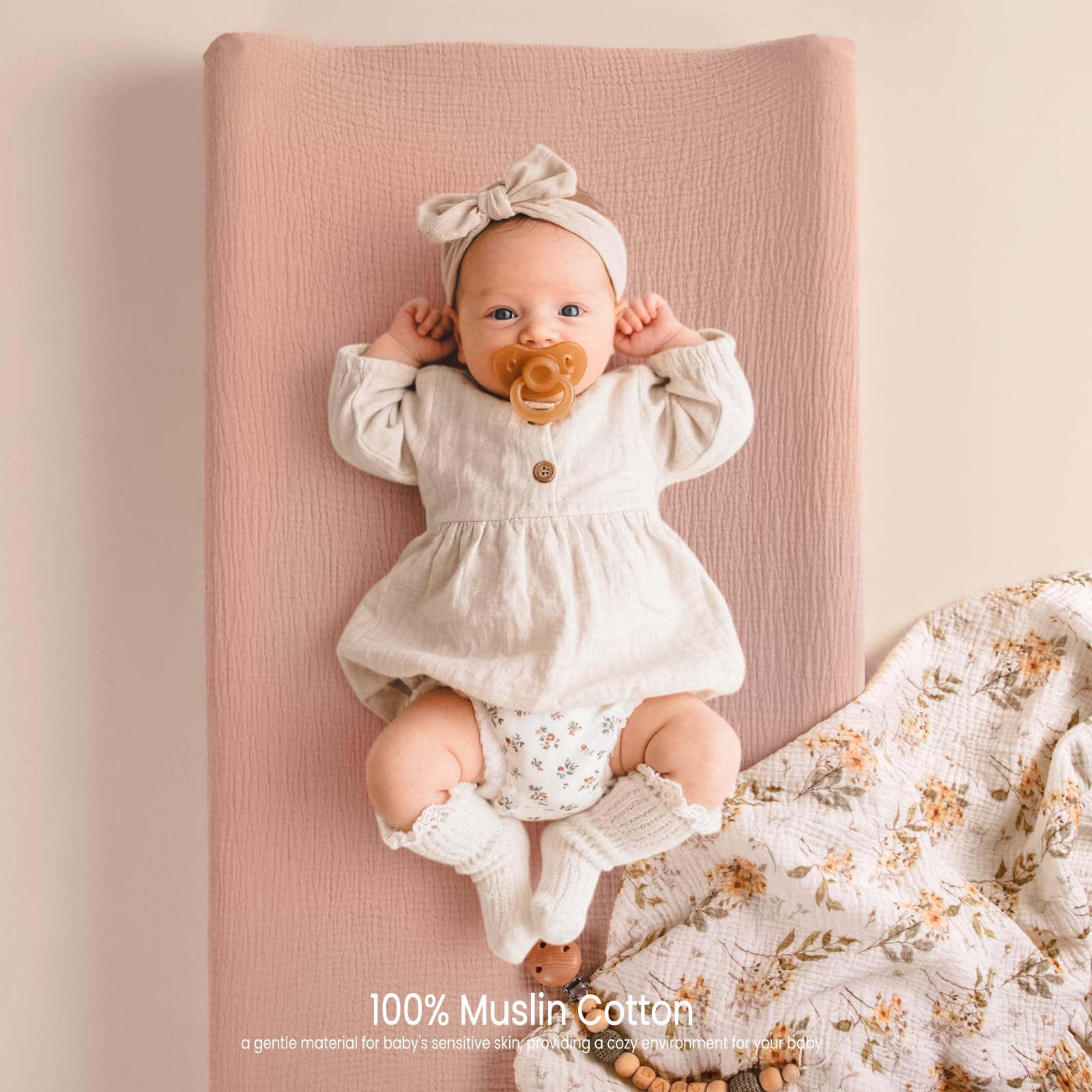 Lulumoon muslin changing pad cover showing buckle openings for easy strap passage.