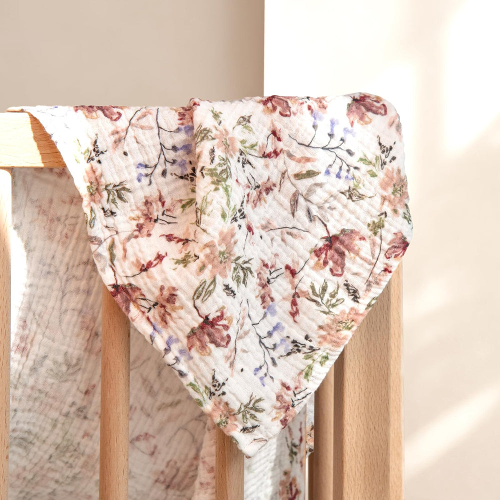 Lulumoon Muslin Swaddle Blanket doubles as burp cloth for quick cleanup.