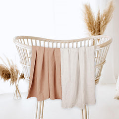 lulumoon muslin swaddle blanket caramel breathable cotton closeup emphasizes gentle touch for newborn skin
