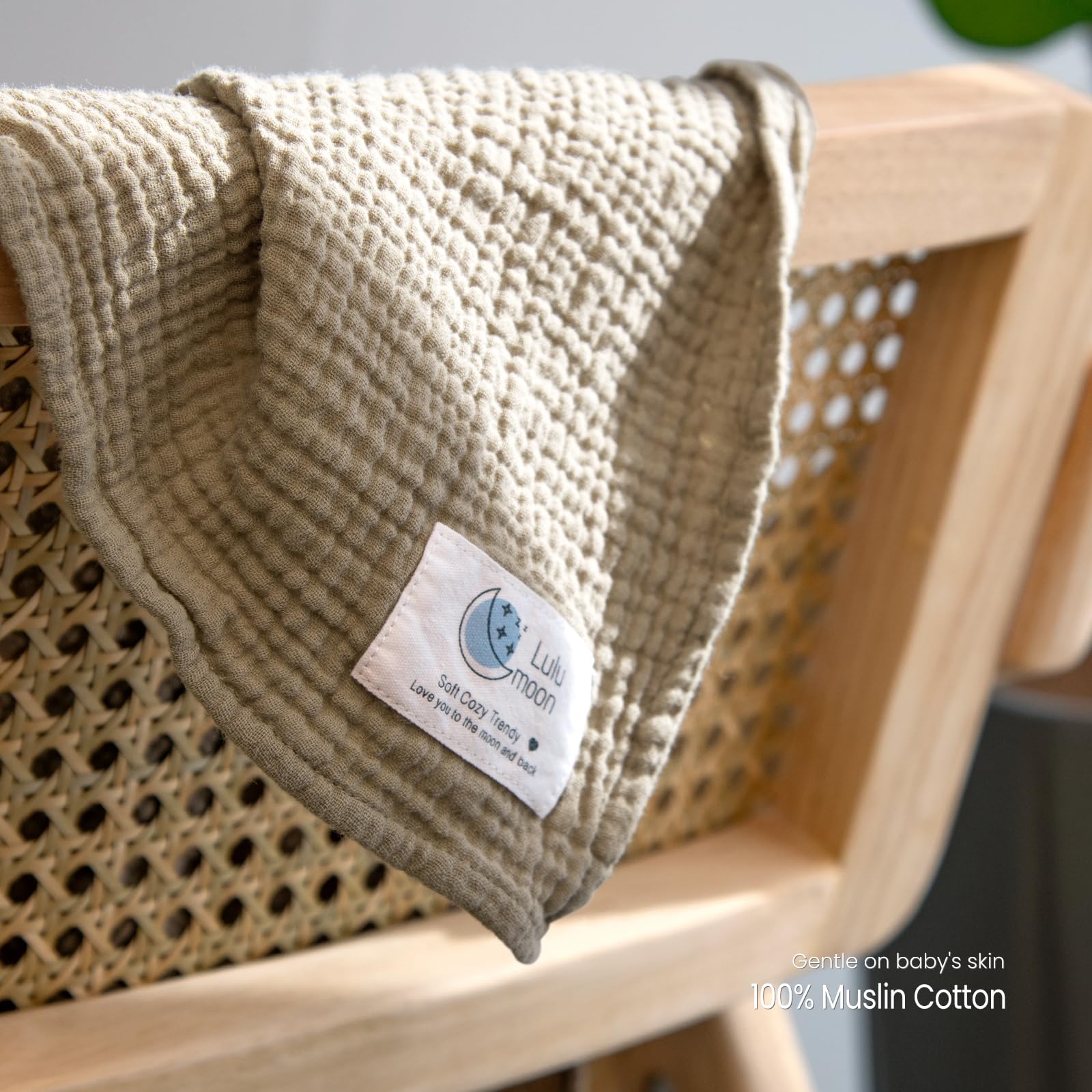 Lulumoon Muslin Swaddle Olive used as nursing cover for discreet feeds.