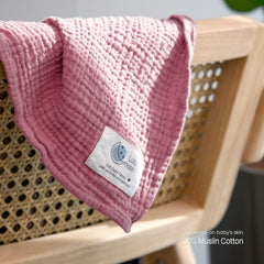 lulumoon muslin swaddle blanket pink close-up reveals soft tone and gentle texture